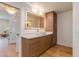 A modern bathroom features a wood cabinet vanity, a lighted mirror, and wood flooring at 2737 E Arizona Biltmore Cir # 8, Phoenix, AZ 85016