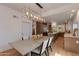 Dining room features a modern chandelier, seating for six, and access to an adjoining kitchen at 2737 E Arizona Biltmore Cir # 8, Phoenix, AZ 85016