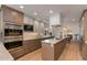 Modern kitchen boasts stainless steel appliances, a center island, and light hardwood flooring at 2737 E Arizona Biltmore Cir # 8, Phoenix, AZ 85016