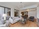 Open concept living room with light wood floors, designer lighting, and access to kitchen at 2737 E Arizona Biltmore Cir # 8, Phoenix, AZ 85016