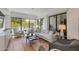 Bright living room features floor-to-ceiling windows with outside views, modern lighting, and stylish furniture at 2737 E Arizona Biltmore Cir # 8, Phoenix, AZ 85016