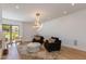 The cozy living area features an eye-catching chandelier, hardwood floors, and comfortable furniture at 2737 E Arizona Biltmore Cir # 8, Phoenix, AZ 85016