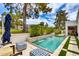Inviting pool features a small rock waterfall, lush backyard landscaping, and comfortable patio seating at 2737 E Arizona Biltmore Cir # 8, Phoenix, AZ 85016