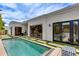 Backyard pool features a tiled pool, artificial turf, patio, and large sliding doors to the home at 2737 E Arizona Biltmore Cir # 8, Phoenix, AZ 85016