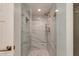 This modern glass enclosed shower features marble accents and brass hardware at 2737 E Arizona Biltmore Cir # 8, Phoenix, AZ 85016