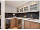 This modern wet bar has sleek cabinets, ample counter space, and updated appliances including a wine cooler at 2737 E Arizona Biltmore Cir # 8, Phoenix, AZ 85016