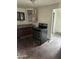 Kitchen featuring basic cabinets and a stainless-steel stove, ready for remodel at 2825 E Adams St, Phoenix, AZ 85034