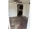 Interior of the living room showing an archway leading to the kitchen, ready for renovation at 2825 E Adams St, Phoenix, AZ 85034