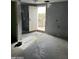 An unfinished room reveals its potential with ample light from the open door and a view to the outside at 2825 E Adams St, Phoenix, AZ 85034
