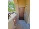 Front door of unit 204 has private porch with neutral concrete tiles and decorative painted wood trim at 29606 N Tatum Blvd # 204, Cave Creek, AZ 85331