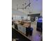 Kitchen with hardwood floors, bar, and black track lighting at 29606 N Tatum Blvd # 204, Cave Creek, AZ 85331