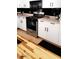 Kitchen with white cabinets, stainless steel oven, and black accents at 29606 N Tatum Blvd # 204, Cave Creek, AZ 85331