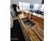 Modern kitchen sink featuring a wooden countertop and sleek faucet with views into living area at 29606 N Tatum Blvd # 204, Cave Creek, AZ 85331