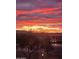 Beautiful sunset behind an apartment building with a view of the parking lot and surrounding landscaping at 29606 N Tatum Blvd # 204, Cave Creek, AZ 85331