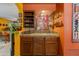 Indoor bar featuring custom cabinetry, backsplash, glassware display and sink at 3416 E Squawbush Pl, Phoenix, AZ 85044