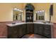Primary bathroom suite with double sinks and a decorative display case at 3416 E Squawbush Pl, Phoenix, AZ 85044