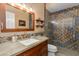 Bathroom featuring colorful tiled shower, vanity, and a sink at 3416 E Squawbush Pl, Phoenix, AZ 85044