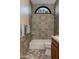 Stylish bathroom featuring unique tiling, a soaking tub, and colorful decorative bottles at 3416 E Squawbush Pl, Phoenix, AZ 85044