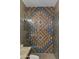 Bathroom featuring custom tiled shower with glass door and chrome fixtures at 3416 E Squawbush Pl, Phoenix, AZ 85044