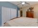 Comfortable bedroom with ample closet space, bed, and dresser with decorative items at 3416 E Squawbush Pl, Phoenix, AZ 85044