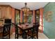 Charming breakfast nook with a colorful light fixture and scenic views from large windows at 3416 E Squawbush Pl, Phoenix, AZ 85044