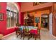 Bright dining room with a large window, colorful walls, and a decorative light fixture above the table at 3416 E Squawbush Pl, Phoenix, AZ 85044