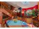 Eclectic dining room with colorful walls, a unique light fixture, and staircase in the background at 3416 E Squawbush Pl, Phoenix, AZ 85044