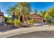 Beautiful stucco home with a tile roof, lush desert landscaping, and mature palm trees at 3416 E Squawbush Pl, Phoenix, AZ 85044