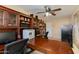 Spacious home office featuring a built-in desk, shelving, and storage cabinets at 3416 E Squawbush Pl, Phoenix, AZ 85044