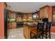 Traditional kitchen with custom cabinets, an island, and tile backsplash and floors at 3416 E Squawbush Pl, Phoenix, AZ 85044