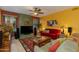 Comfortable living room featuring colorful walls, ceiling fan and plush seating at 3416 E Squawbush Pl, Phoenix, AZ 85044