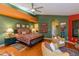 Large primary bedroom suite with hardwood floors, sitting area, and unique colorful walls at 3416 E Squawbush Pl, Phoenix, AZ 85044