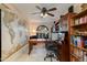 A home office featuring built-in bookshelves, a desk, and a world map at 3416 E Squawbush Pl, Phoenix, AZ 85044