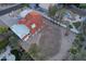 Backyard aerial view features an empty sport court, desert landscaping, and a charming red tile roof at 3738 E Kachina Dr, Phoenix, AZ 85044