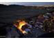 Aerial view showcases a community with a beautiful home and a serene desert backdrop at night at 3738 E Kachina Dr, Phoenix, AZ 85044