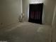 Unfinished room with black curtains and a stylish lamp on a decorative side table at 3738 E Kachina Dr, Phoenix, AZ 85044
