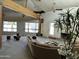 Spacious living room with vaulted ceilings, exposed beams, and large windows overlooking the yard at 3738 E Kachina Dr, Phoenix, AZ 85044