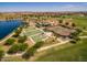 Aerial view of the community amenities including a lake, sports fields, and courts at 42468 W Palmyra Ct, Maricopa, AZ 85138