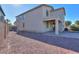 View of the home's backyard featuring a patio and stone ground covering at 42468 W Palmyra Ct, Maricopa, AZ 85138