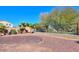 Backyard featuring trees, fence, and stone ground covering at 42468 W Palmyra Ct, Maricopa, AZ 85138