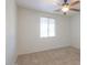 Well-lit bedroom with carpet, ceiling fan, and window view at 42468 W Palmyra Ct, Maricopa, AZ 85138