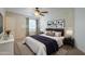 Staged bedroom with neutral tones and ceiling fan at 42468 W Palmyra Ct, Maricopa, AZ 85138
