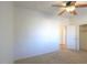 Spacious bedroom with carpet, ceiling fan, and closet access at 42468 W Palmyra Ct, Maricopa, AZ 85138