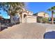 Two-story home with a two car garage, low maintenance rock yard, and a long driveway at 42468 W Palmyra Ct, Maricopa, AZ 85138