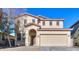 Charming two-story home with a red tile roof, arched entryway and a two car garage at 42468 W Palmyra Ct, Maricopa, AZ 85138