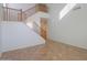 Bright foyer area with a staircase featuring wooden banisters and tile flooring at 42468 W Palmyra Ct, Maricopa, AZ 85138