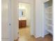 Hallway view leading to bathroom and adjacent storage closet at 42468 W Palmyra Ct, Maricopa, AZ 85138