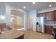 Open kitchen with breakfast bar, stainless steel appliances, and dark wood cabinets at 42468 W Palmyra Ct, Maricopa, AZ 85138
