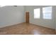 Bright room featuring tile floors, high ceilings and natural lighting from two large windows at 42468 W Palmyra Ct, Maricopa, AZ 85138