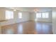 A large, open-concept living room with tan tile flooring and plenty of natural light at 42468 W Palmyra Ct, Maricopa, AZ 85138